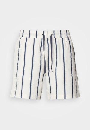 Shorts blancs avec des rayures verticales bleu marine. Dotés d'une taille élastique avec un cordon de serrage. Tissu léger avec une texture lisse et un ourlet fini avec soin.