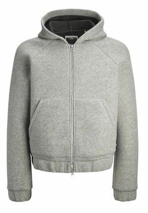 Halli hall ja mustritolmu zip-up jakiga, millel on eesneule ja nööbid, tõmbetrossiga kapuuts ning küljetaskud. Omab raglan varrukaid ja ribaga hemmi ning mansette.