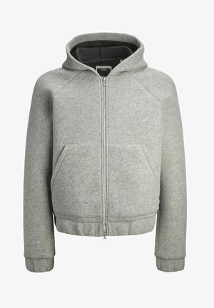 Halli hall ja mustritolmu zip-up jakiga, millel on eesneule ja nööbid, tõmbetrossiga kapuuts ning küljetaskud. Omab raglan varrukaid ja ribaga hemmi ning mansette.