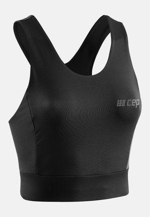 Reggiseno sportivo nero con scollatura a giro, spalline larghe e un elastico aderente nella parte inferiore. Realizzato in materiale morbido e elastico.