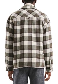 Geruit flanellen overhemd in groen en wit, met een klassieke kraag, knoopmanchetten en een ontspannen pasvorm, gemaakt van een gestructureerde stof met zichtbare naden.