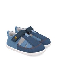 Zapatillas de lona azules con una textura suave, que cuentan con una correa de velcro, paneles de malla gris y una suela de goma blanca. Acabadas con costuras naranjas.