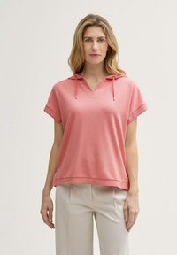 Helle rosa Kapuzenjacke mit kurzen Ärmeln und V-Ausschnitt, aus weichem Material gefertigt. Verfügt über einen lockeren Schnitt und dezente Texturdetails.