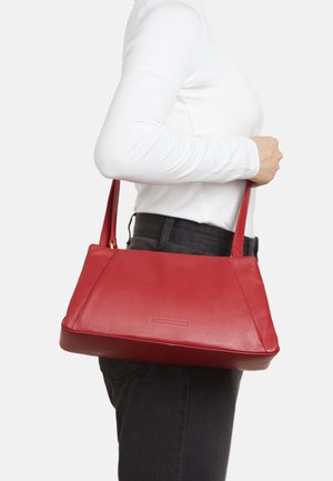 Red leather handbag with two top handles, a flat base, and a structured design. Features a subtle logo on the front.
