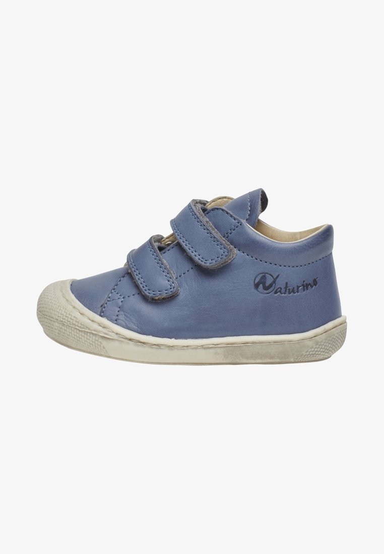 Blue toddler shoe with two velcro straps and a white rubber sole, showing slight wear.