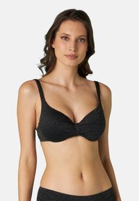 Soutien-gorge nero con texture in rete e piccoli punti dorati, caratterizzato da una scollatura profonda a V, spalline regolabili e supporto con ferretto.