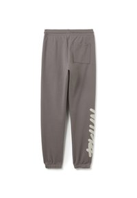 Graue Jogginghosen aus weichem Stoff mit elastischem Bund, Bündchen an den Knöcheln und Seitentasche. Auffälliges grafisches Design am Bein.