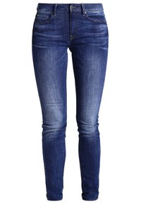 Smala jeans i mörkblå denim med en blekt tvätt, fem fickor och subtila sömdetaljer. Slät textur och skräddarsydd design.