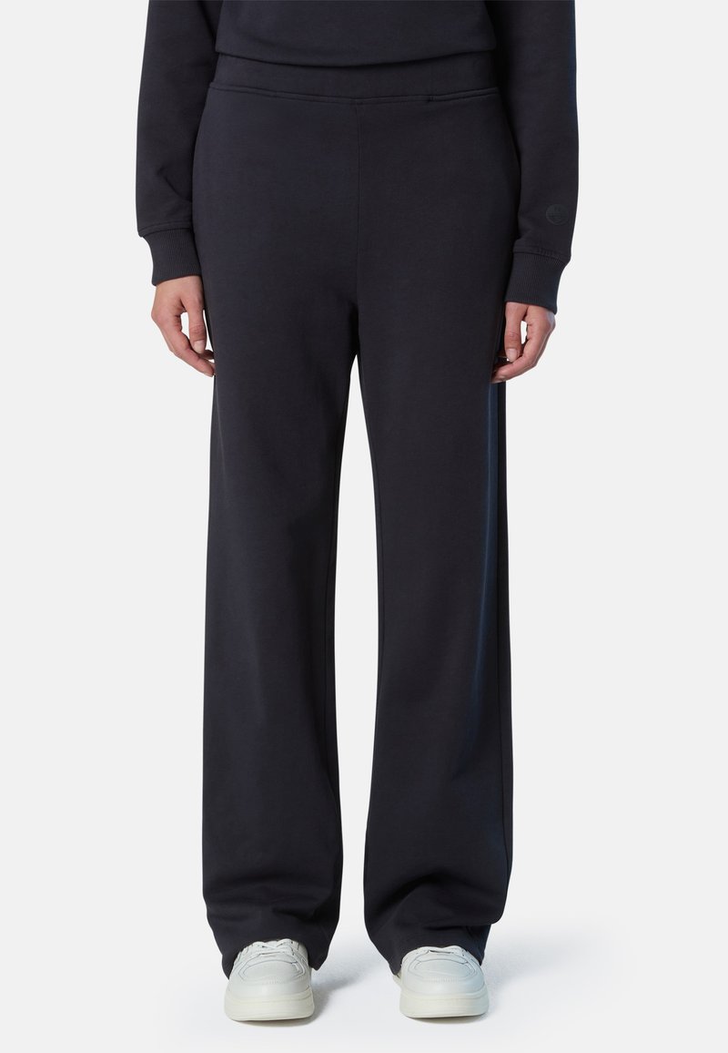 Pantalones de chándal azul marino con un corte relajado, hechos de tejido suave. Presentan una cinturilla elástica y puños acanalados. Diseño minimalista sin patrones.