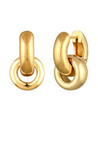 Boucles d'oreilles en forme de créole de couleur or, présentant un design lisse et arrondi avec des éléments circulaires entrelacés et une finition polie.