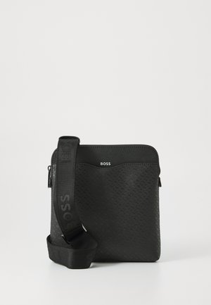Sac bandoulière noir avec motif texturé, fermeture éclair, poche avant et large bandoulière réglable avec la marque "BOSS" en noir assorti.