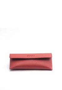 Red textured leather eyeglass case with a flap closure, featuring embossed "GUESS" logo on the front and a soft, rounded shape.