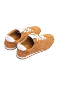 Brown suede sneakers with white laces and accents. Rounded toe, textured surface, cushioned interior, and contrasting white rubber sole.
