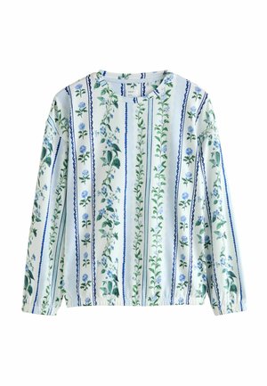 Bluzka z długim rękawem w jasnoniebieskim i białym kwiatowym wzorze z pionowymi paskami. Posiada elastyczne mankiety i okrągły dekolt.