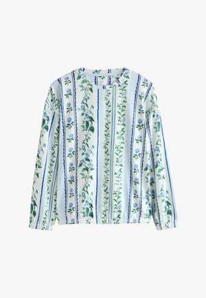 Bluzka z długim rękawem w jasnoniebieskim i białym kwiatowym wzorze z pionowymi paskami. Posiada elastyczne mankiety i okrągły dekolt.