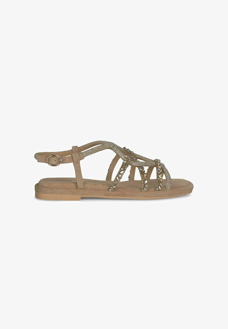 Beige sandalen met bandjes en decoratieve metalen accenten, open teen ontwerp en een platte zool. Voorzien van een gespsluiting voor aanpassing.