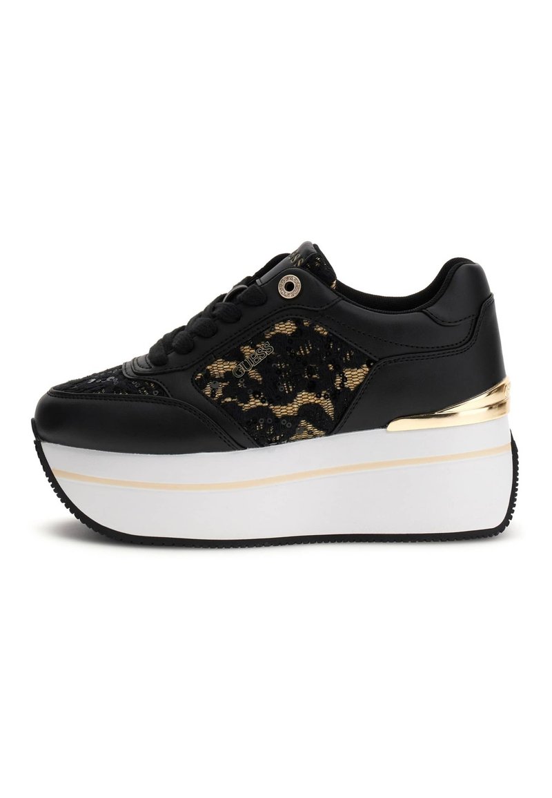 Black sneaker with a textured black and gold fabric upper, chunky white platform sole, and gold accent along the heel. Lace-up design.