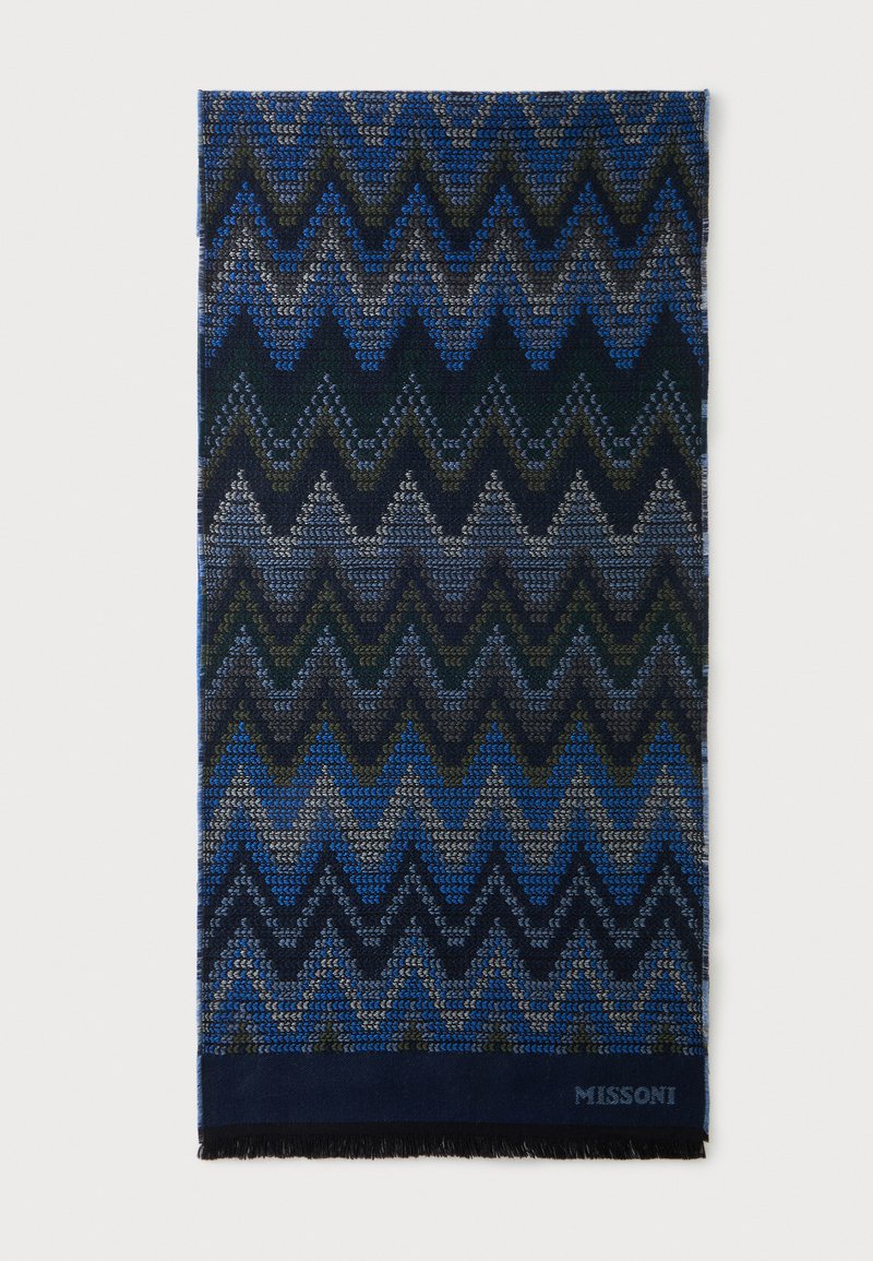 Écharpe rectangulaire avec motif zigzag bleu, noir et gris et petites franges en bas.
