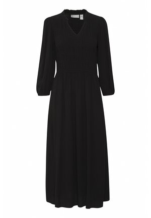 Fekete ruha v kivágással, smockolt mellrésszel és hosszú puffos ujjakkal. Könnyű anyagból készült, amely laza sziluettet ad.