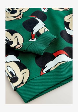 Hanorac verde cu un model repetat de fețe de personaje de desene animate, cu accente roșii pe pălării de Crăciun și manșete texturate.