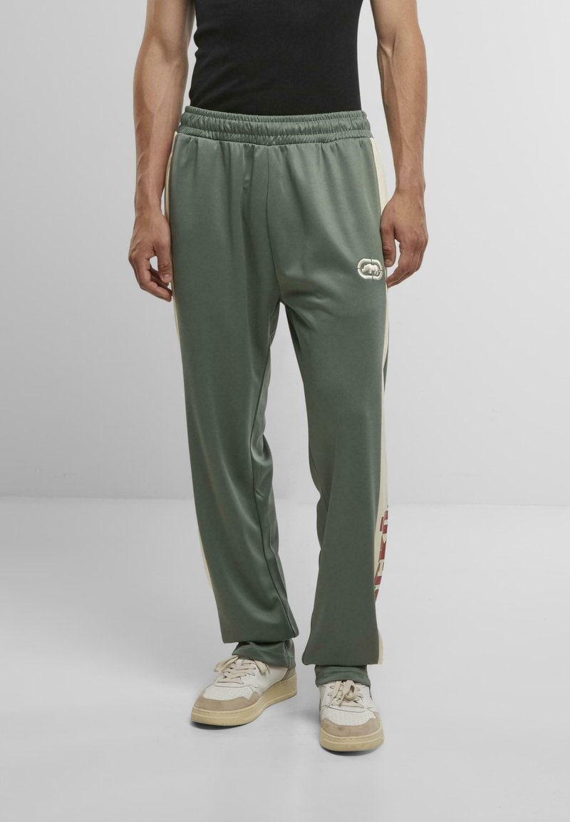 Grüne Sporthose mit lässiger Passform, elastischem Bund und seitlichen Einsätzen. Verfügt über ein Logodetail und ergänzende cremfarbene Akzente.