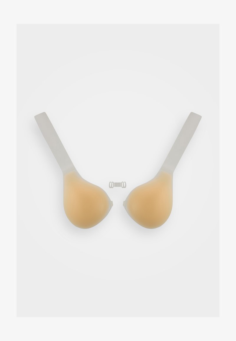 Silicone adhesive bra cups in beige with clear straps. Smooth texture, rounded shape, and a small plastic clip included for fastening.