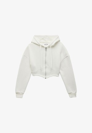 Biała, krótka bluza z kapturem na zamek błyskawiczny z przodu, ze sznurkiem w kapturze i szerokimi rękawami, wykonana z miękkiego, fakturowanego materiału o minimalistycznym wzorze.