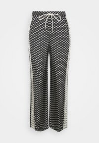 Pantalon à motifs noir et blanc avec une taille élastique, un cordon de serrage et des bandes latérales contrastées. Coupe ample à jambes larges pour un confort décontracté.