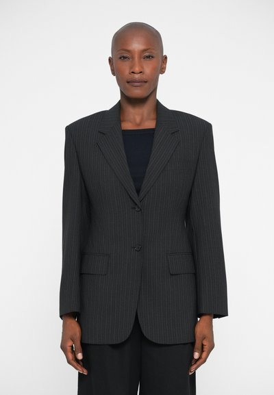 Pinstripe blazer in dark gray, featuring a structured design, notch lapels, and two front pockets. Fabric has a smooth texture.