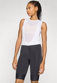 Schwarze Radsport-Shorts mit einem weißen Mesh-Oberteil. Merkmale sind ein Rundhalsausschnitt, gepolsterter Sitz und elastische Beinbündchen für Komfort und Passform.