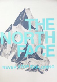 White t-shirt featuring a blue mountain graphic with the text "THE NORTH FACE" and "NEVER STOP EXPLORING" in bold turquoise font.