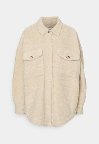 Beige Fleece-Übershirt mit Kragen, zwei Brusttaschen und goldfarbener Knopfverzierung. Weicher Stoff und lockere Passform. Runde Saumlinie.