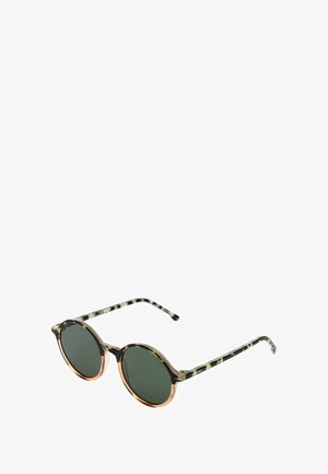 Lunettes de soleil rondes au design bicolore ; monture avec motif noir et doré, verres verts et fines branches à motif.