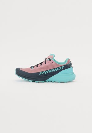 Trail running shoe with a pink upper, navy toe cap, and turquoise accents. Features laces and textured outsole for grip.
