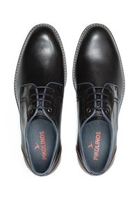 Chaussures en cuir noir avec des lacets bleus, bout rond et détails cousus. L'intérieur présente le logo "Pikolinos" sur une semelle intérieure bleue.