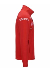 Giacca in pile rossa con colletto alto, caratterizzata da loghi bianchi sulle maniche e sul petto. Presenta tasche laterali e un design aderente.