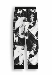 Czarno-białe dresy mają miękką tkaninę, elastyczny pas i ściągacze z prążkowanej dzianiny, ozdobione abstrakcyjnym wzorem pędzla.