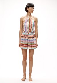 Πολύχρωμο ολόσωμο σορτς με σχέδιο ζιγκ-ζαγκ και δέσιμο στο λαιμό, με ελαστική μέση, σε αποχρώσεις ροζ, μπλε και πορτοκαλί, κατασκευασμένο από ελαφρύ ύφασμα.
