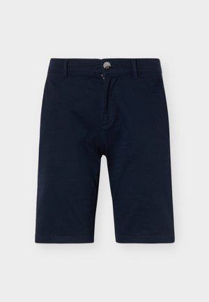 Marineblå knælange shorts med knap og lynlås, bæltestropper og fladt frontdesign på en ensfarvet baggrund.