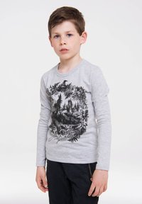 Gray long-sleeve shirt featuring a black graphic design of a castle surrounded by foliage and animals, with the word "Majesty" in cursive.