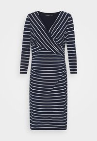 Marinblå och vit randig omlottklänning med långa ärmar, som har en figursydd silhuett och draperad detalj vid midjan. Mjuk och stretchig material.