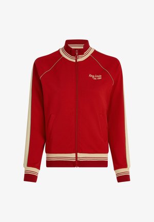 Chaqueta roja con cierre de cremallera y detalles en crema, cuello acanalado, mangas largas y bolsillos laterales. Presenta el bordado "King Louie Est. 1989" en el frente.