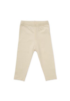 Beige leggings made of soft fabric with an elastic waistband and a slim fit. No patterns or embellishments are present.
