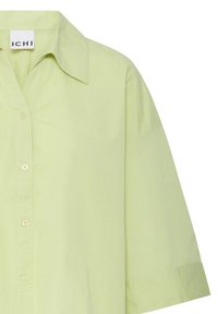 Chemise vert clair à boutons avec col pointu et manches mi-longues, en tissu lisse, vue de face avec quatre boutons.