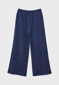 Tmavomodré nohavice s širokými nohavicami a elastickým pásom, položené na svetlosivom pozadí.