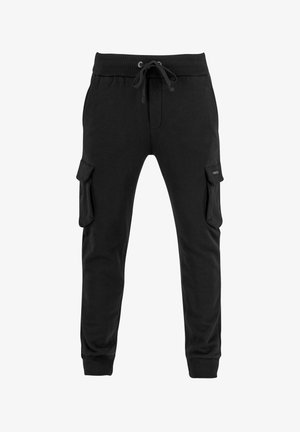 Schwarze Sweatpants aus Baumwolle, mit einem Kordelzugbund, schmal zulaufendem Bein und zwei großen Cargo-Taschen an den Seiten.