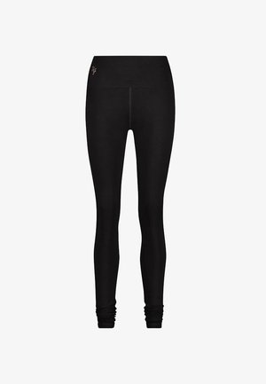 Mustat legginsit, jotka on valmistettu joustavasta kankaasta. Ne sisältävät leveän vyötärönauhan, kireän muotoilun ja hienovaraisen logokuvion vyötärönauhassa.