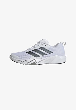 Zapato deportivo blanco con parte superior de malla, tres rayas plateadas, suela acolchada y un diseño pronunciado en zigzag. Cuenta con una lengüeta en el talón para facilitar su colocación.