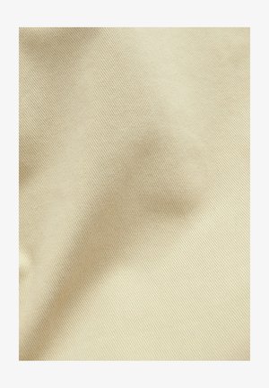 Beige-tekstuuri kangas, millel on peen sooneline muster, mis näitab kergeid kortse, mis viitab pehmele, keskmise raskusega materjalile.