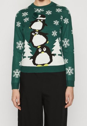 Groene gebreide trui met een pinguïnontwerp en witte sneeuwvlokken en bomen. Ribgebreide manchetten en onderkant. Pomponaccent op de bovenste pinguïn.